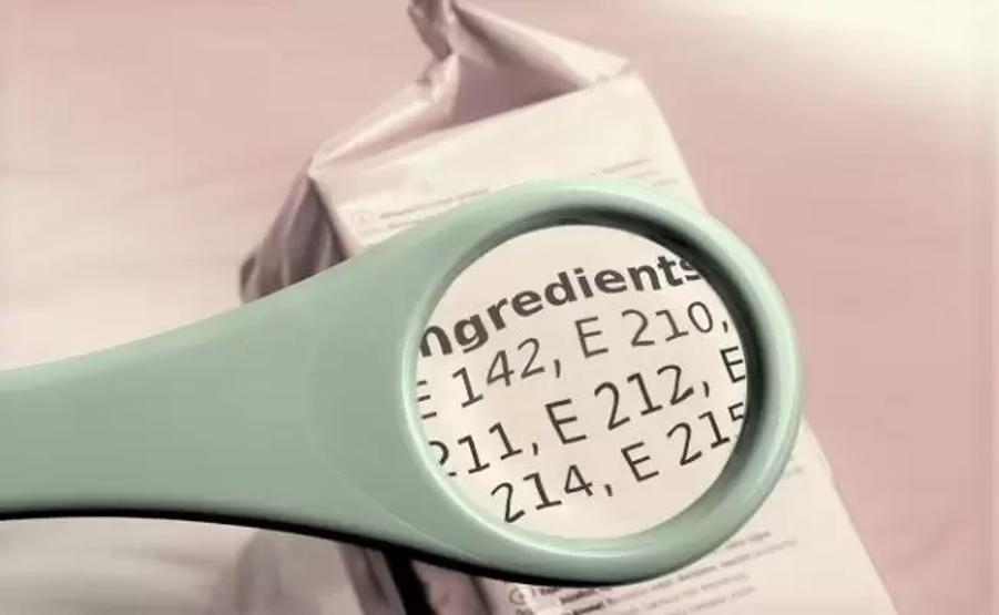 Magnifying glass highlighting E numbers on a food label