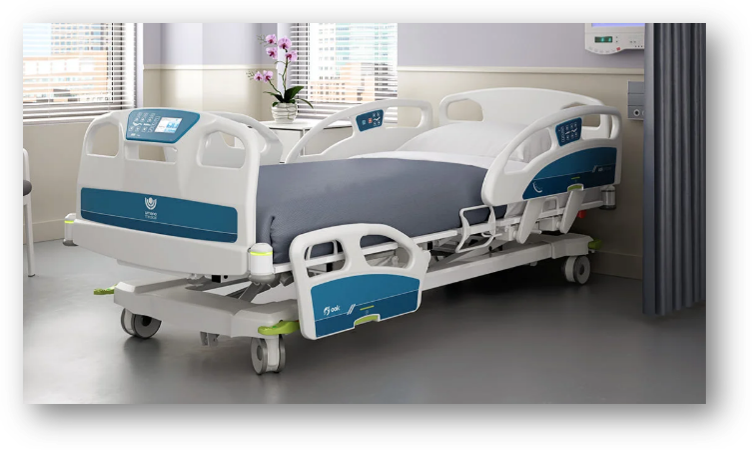 Image of a hospital bed with side handles and end board, made up with pillows and a grey blanket